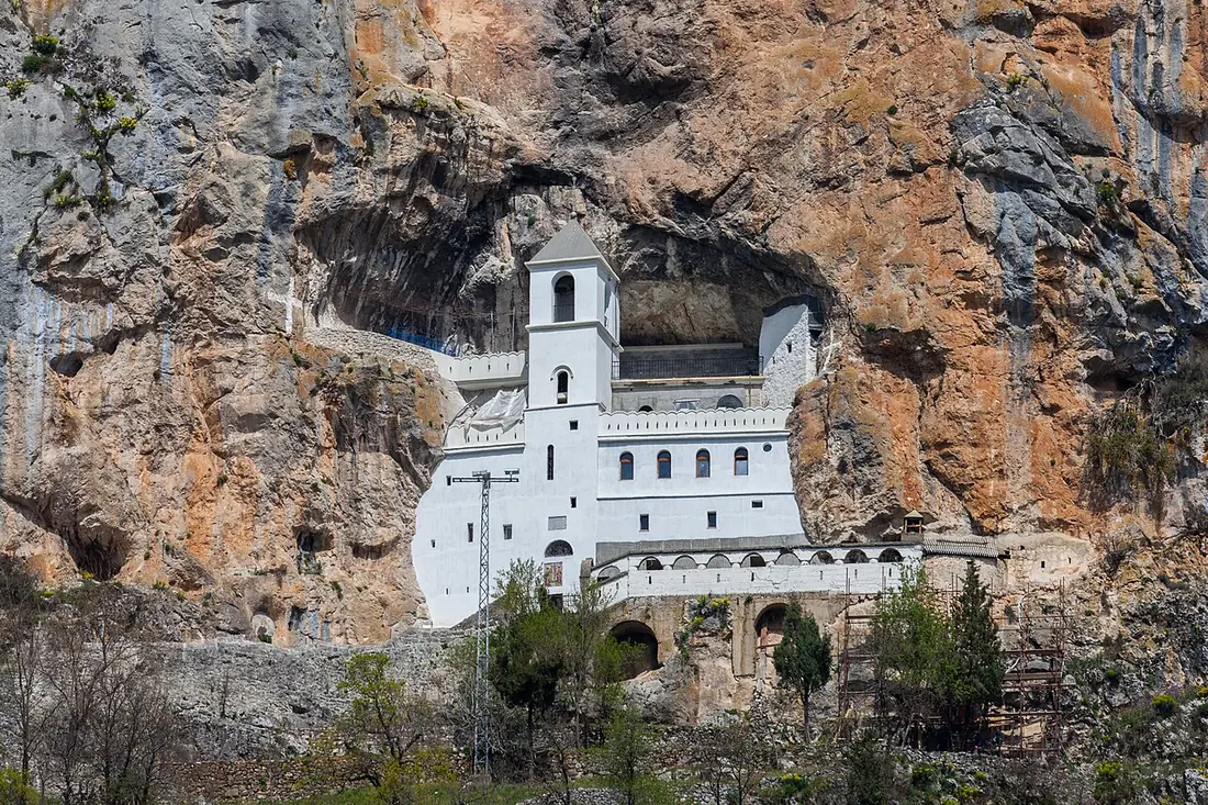 White upper Ostrog Monastery set into a sheer cliff